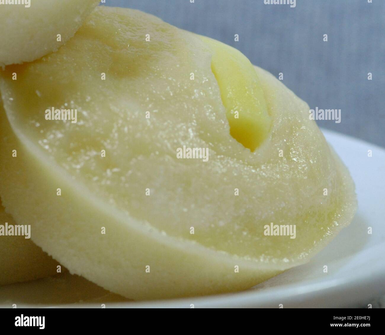 Close up shot of freshly baked Filipino dessert rice cake with cheese toppings in a soft background. Stock Photo