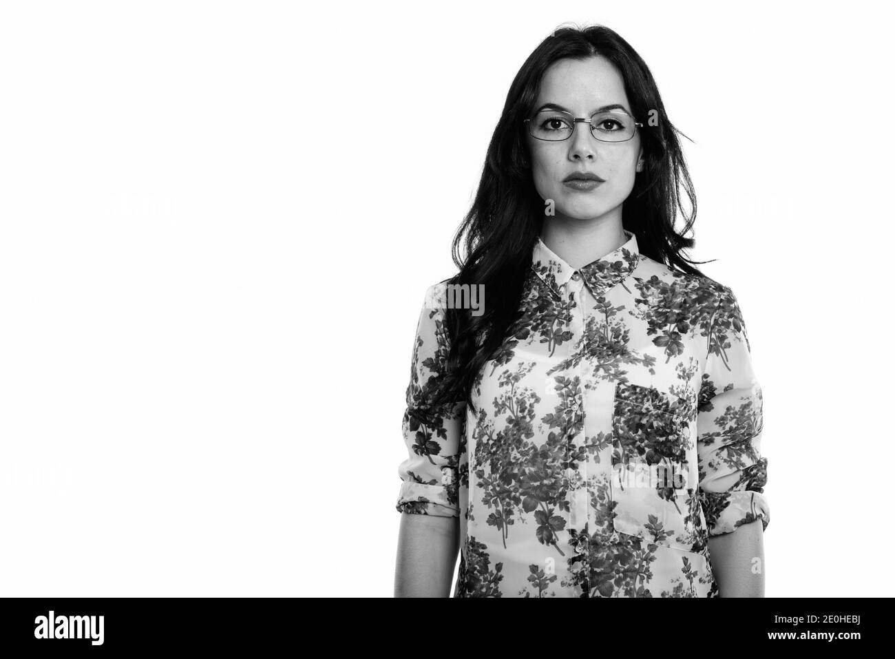 Studio shot of young beautiful Spanish businesswoman wearing eyeglasses