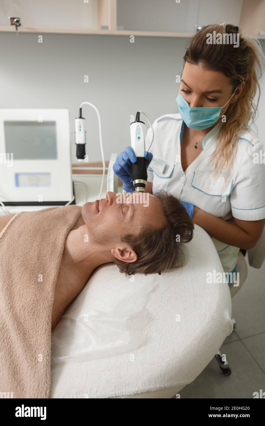 Vertical shot of a professional dermatologist in medical face mask
