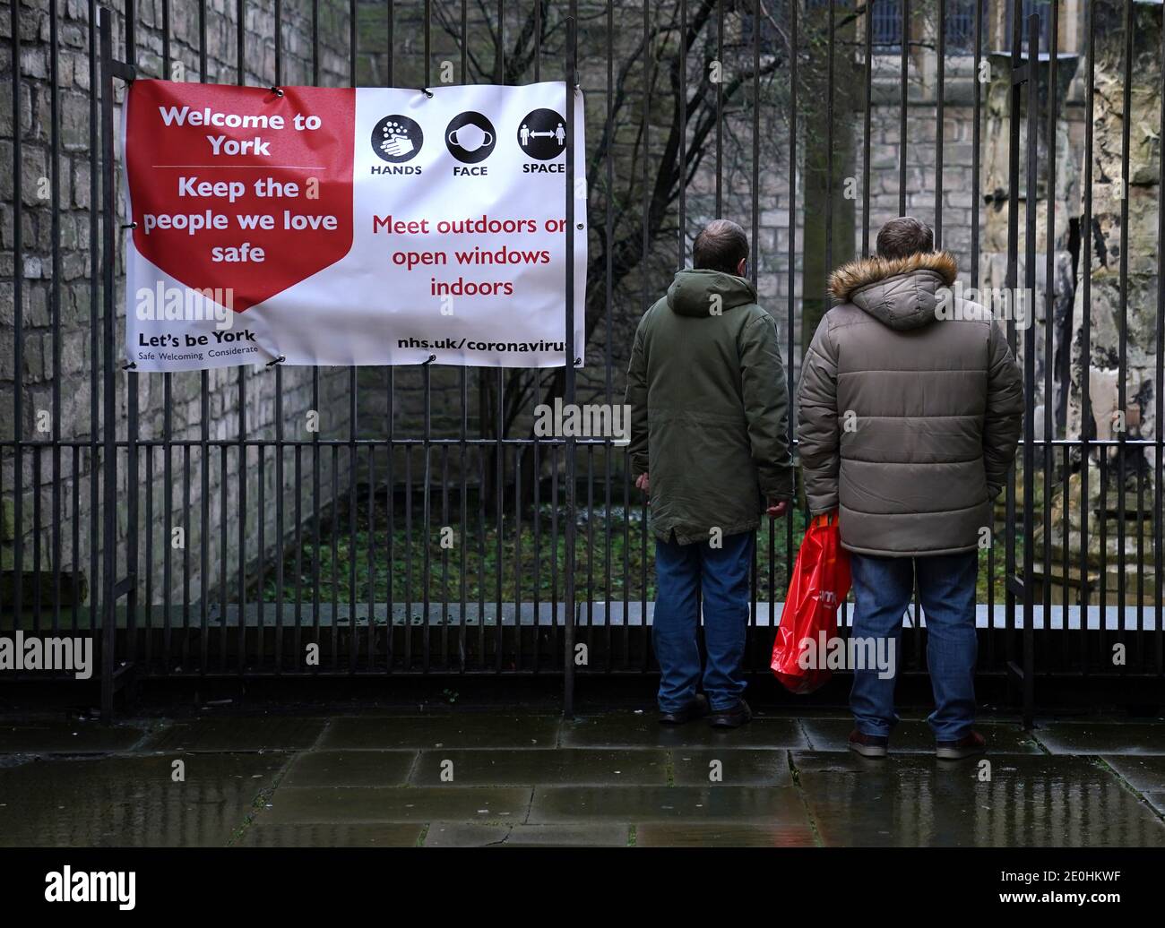 Shoppers stop to look at building ruins in York City Centre. More than three quarters of England's population is being ordered to stay at home to stop the spread of coronavirus. Stock Photo