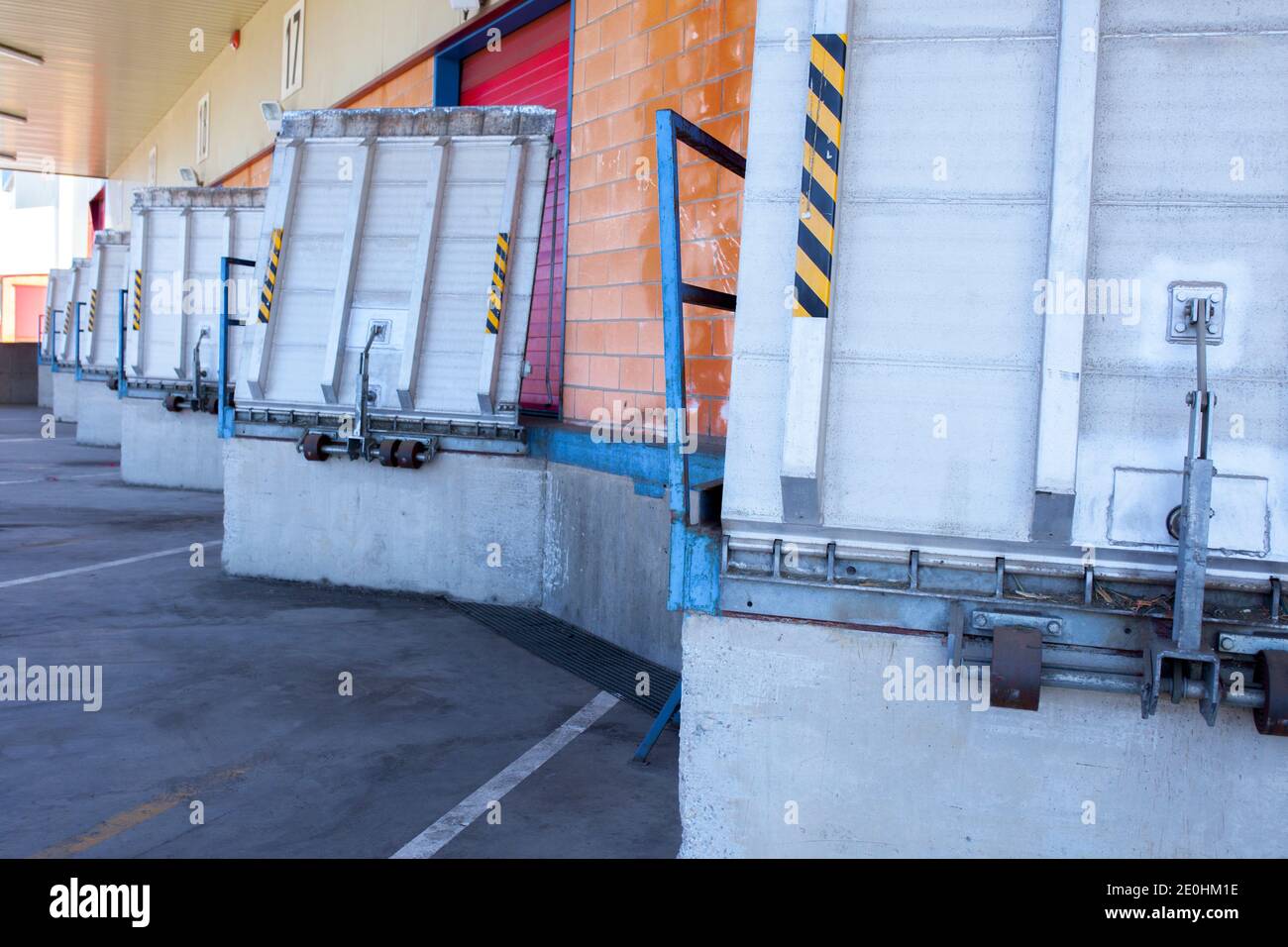 Truck loading docks at commercial building. Overhead door, dock leveler, and dock seals Stock Photo