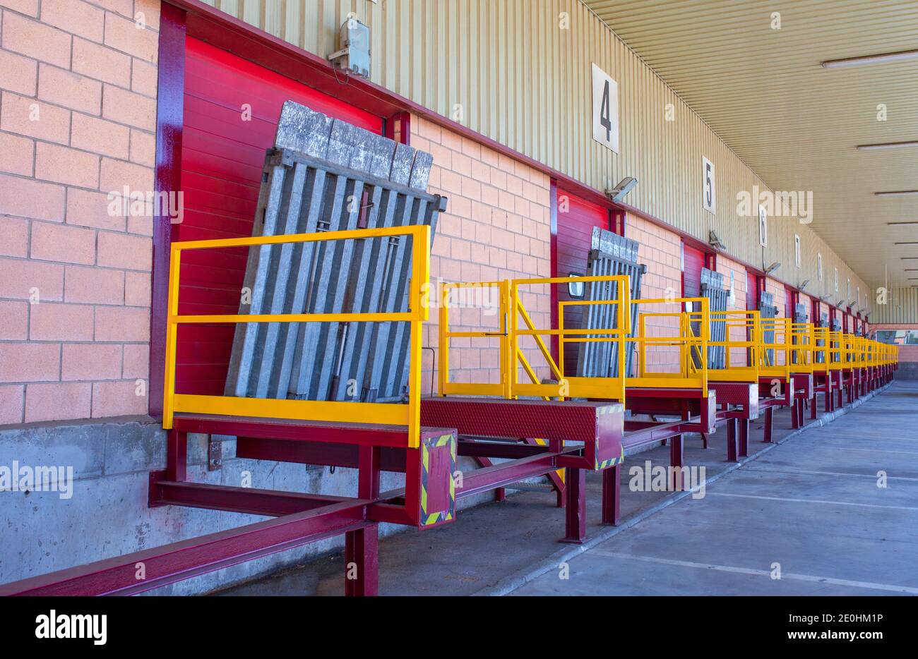 Truck loading docks at commercial building. Overhead door, dock leveler, and dock seals Stock Photo