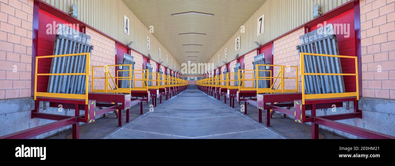 Truck loading docks at commercial building. Overhead door, dock leveler, and dock seals Stock Photo