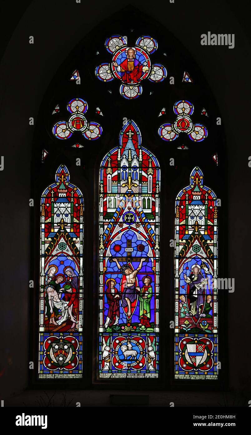 A stained glass window by Clayton & Bell depicting The Crucifixion, Deposition and Resurrection of Jesus, St Margaret's Church, Witton, Norfolk. Stock Photo