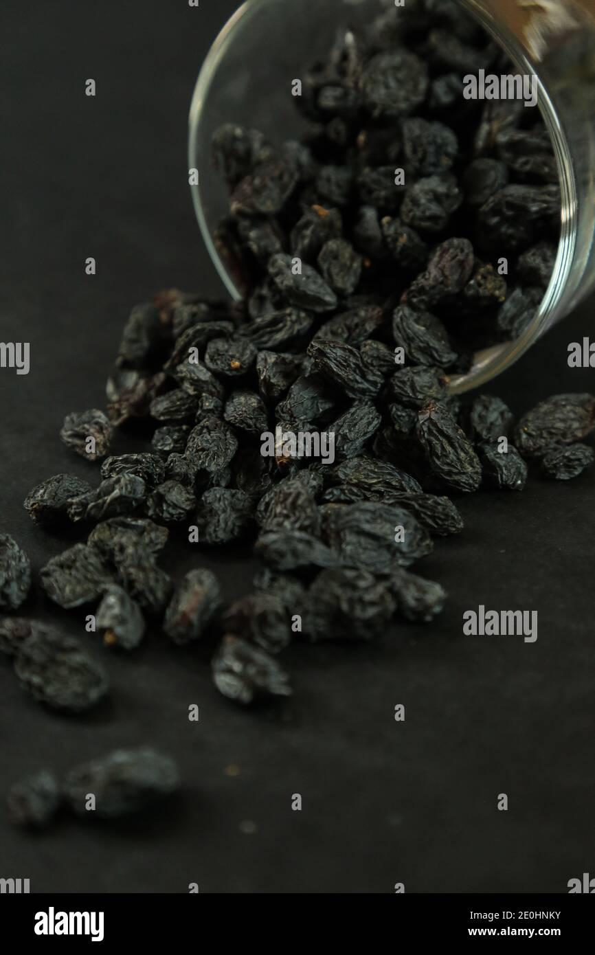 Dried raisins on white background Stock Photo - Alamy