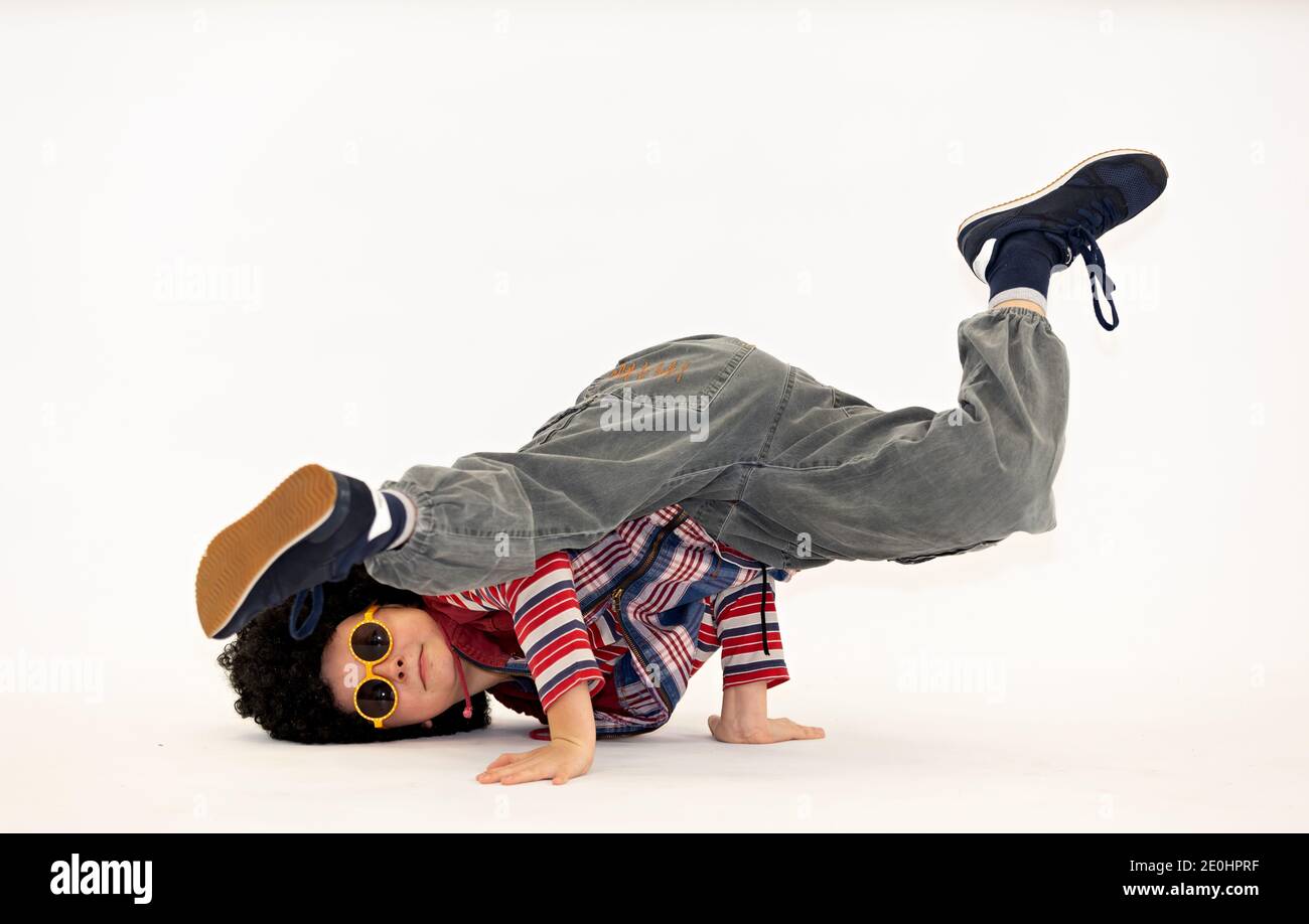 a boy with an afro haircut in a breakdance pose Stock Photo