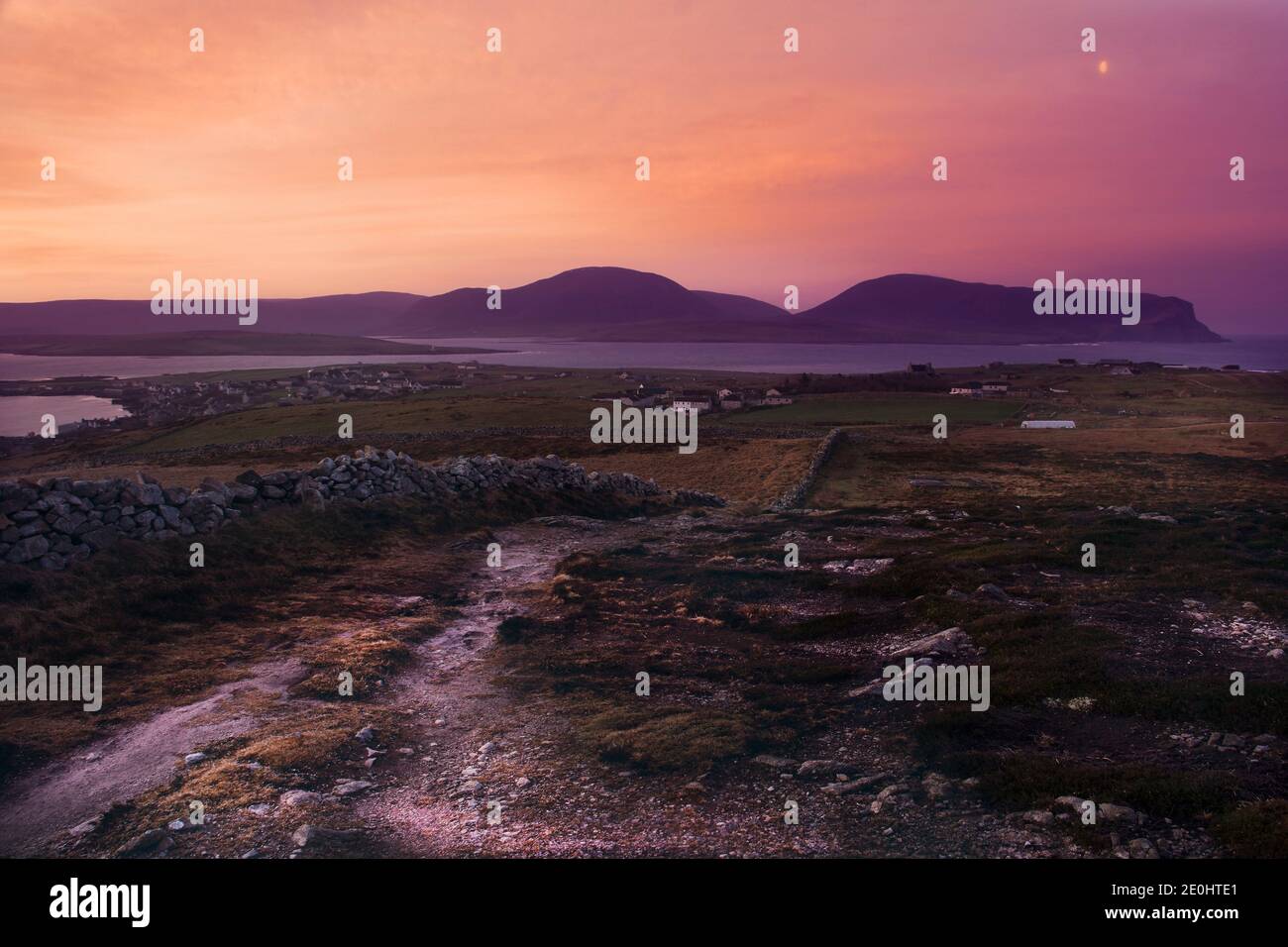 Purple color sky during sunrise above Orkney islands town Stromness Stock Photo