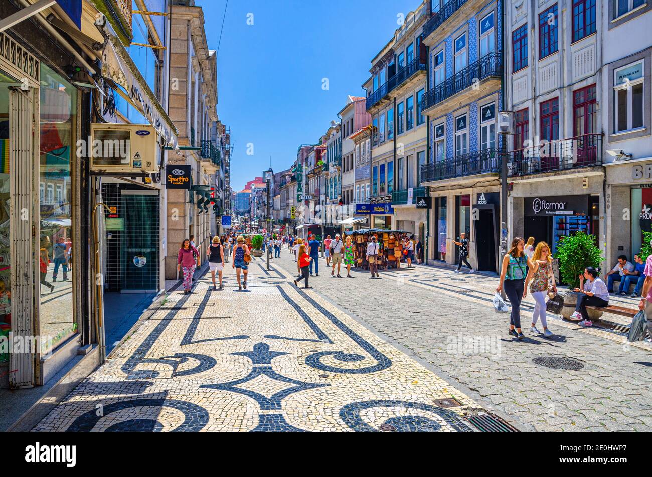 Porto, Portugal, June 23, 2017: people tourists walking down Rua de Santa Catarina cobblestone pedestrian street with colorful buildings and houses in historical city centre in sunny summer day Stock Photo