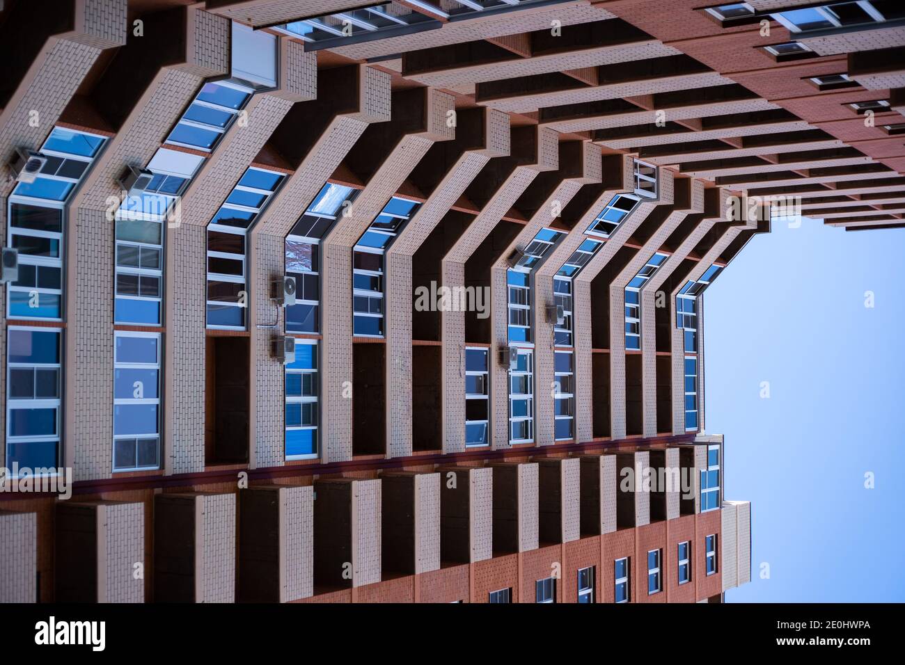 facade of a tall brick apartment building. Construction and real estate. Buying and selling an