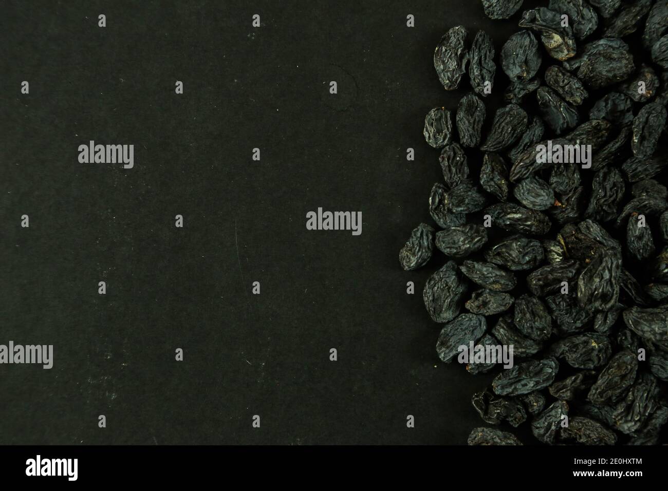 Dried raisins on black background Stock Photo