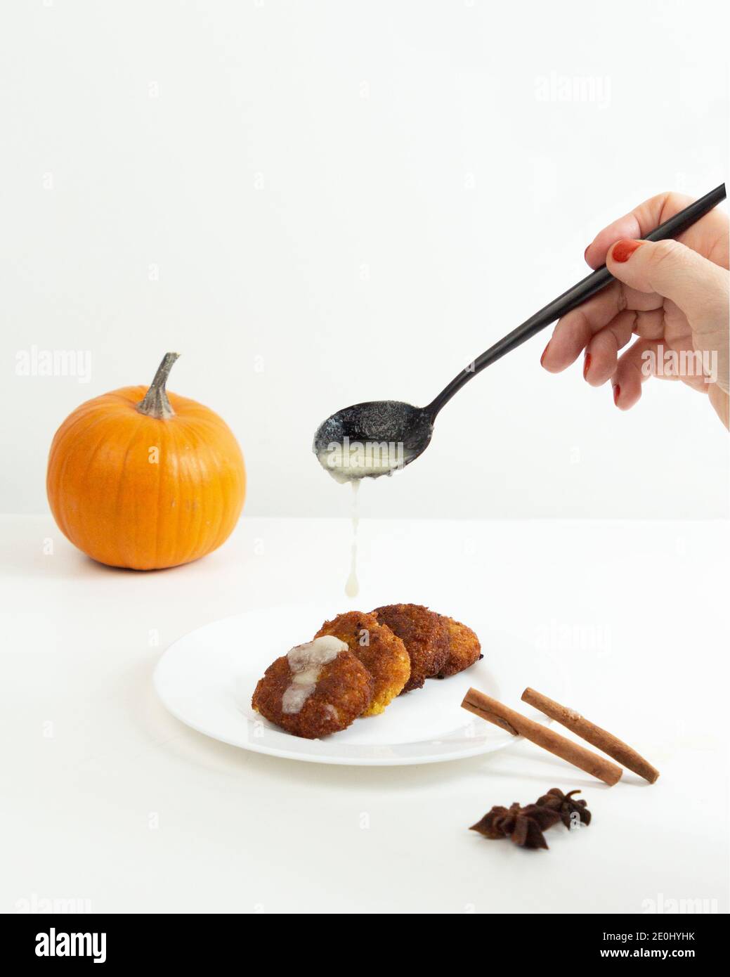 Traditional Peruvian food Picarones. Homemade fried pumpkin donuts. On white background. Stock Photo