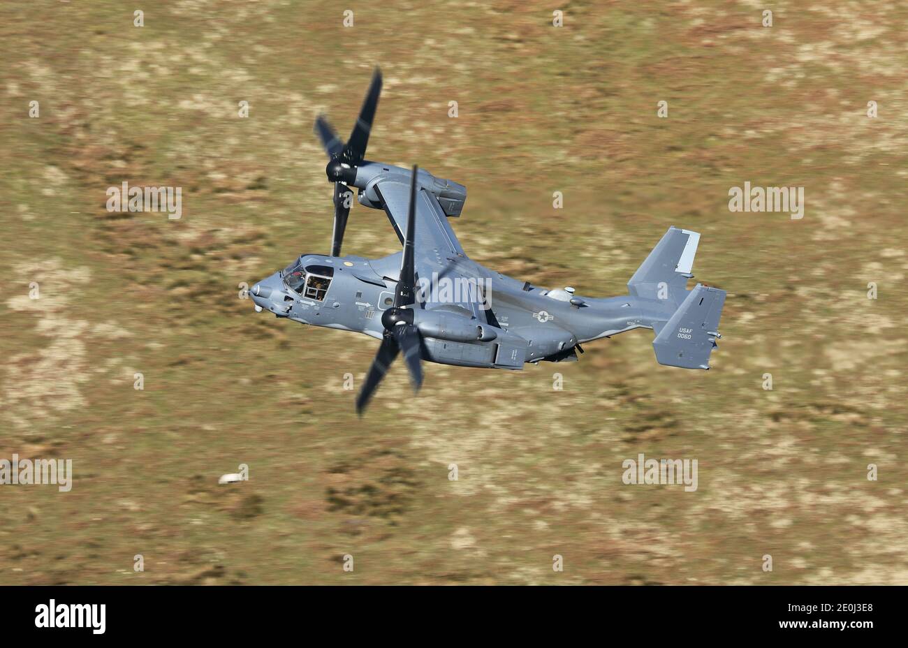 USAF CV-22 Osprey tiltrotor aircraft flying in the 'mach loop' area of Wales, UK. Stock Photo