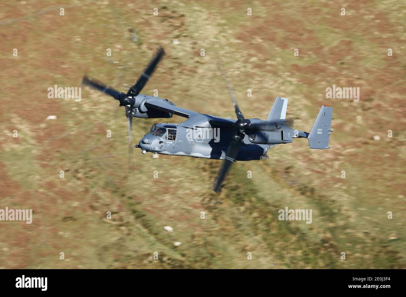 USAF CV-22 Osprey tiltrotor aircraft flying in the 'mach loop' area of Wales, UK. Stock Photo