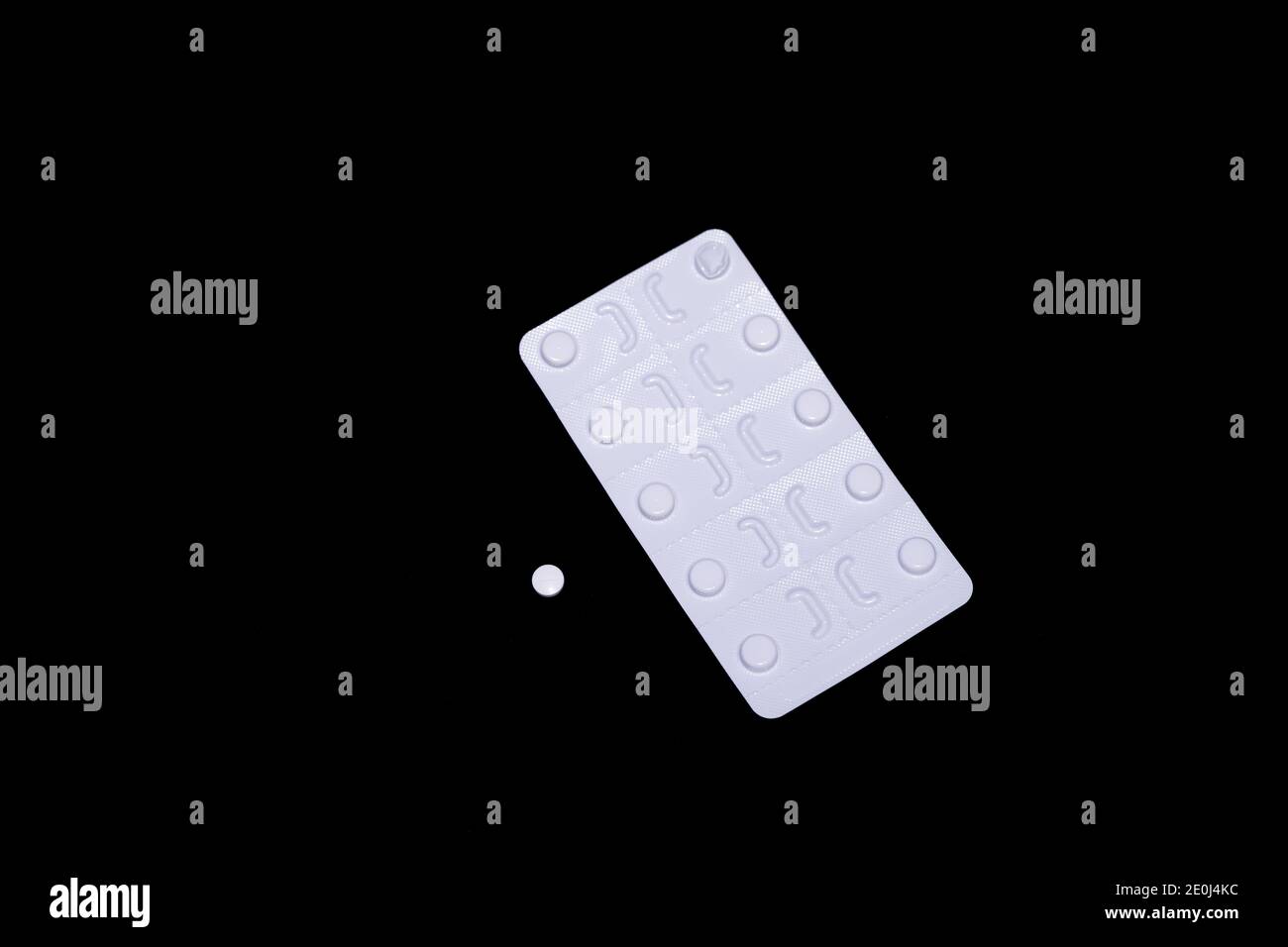 Provera (medroxyprogesterone acetate) 10mg pills with packet, blister pack and individual tablet on a black background.  Treats abnormal bleeding. Stock Photo
