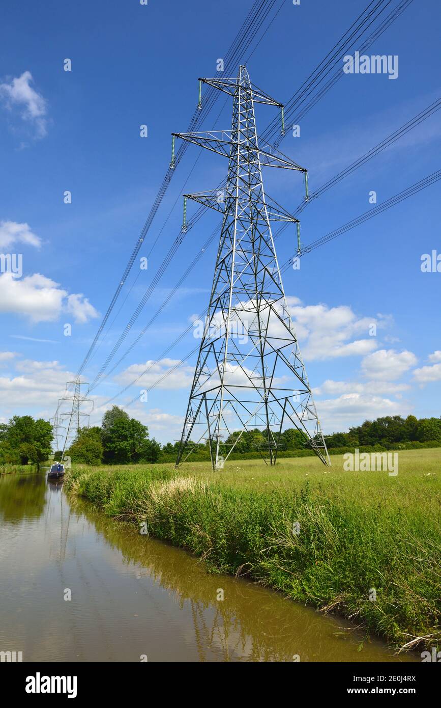 Electricity Pylons carrying overhead power lines across fields, Ashby Canal, Swadlincote, Midlands, United Kingdom Stock Photo
