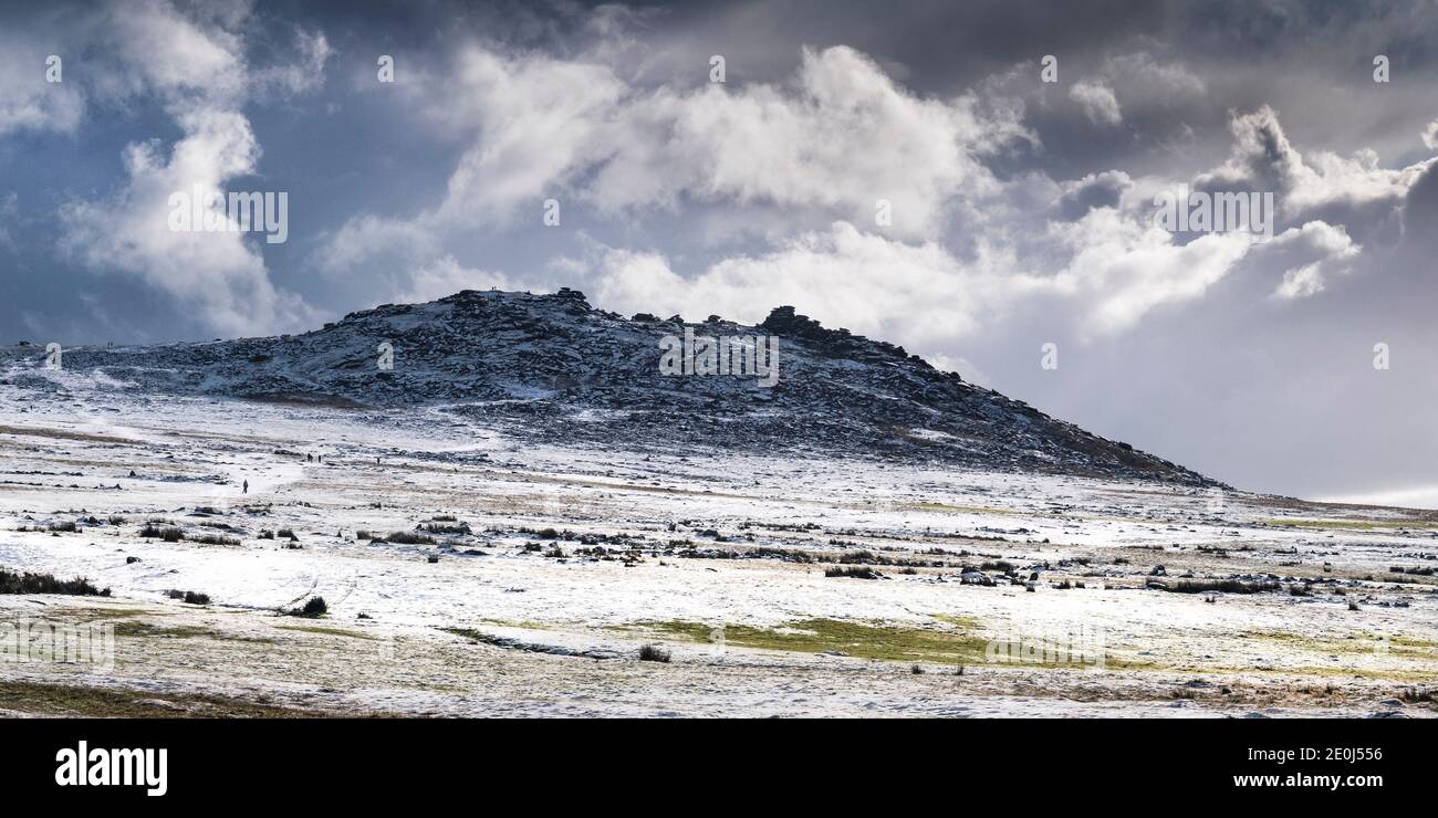 A panoramic image of snow on the wild rugged Rough Tor on Bodmin Moor in Cornwall. Stock Photo