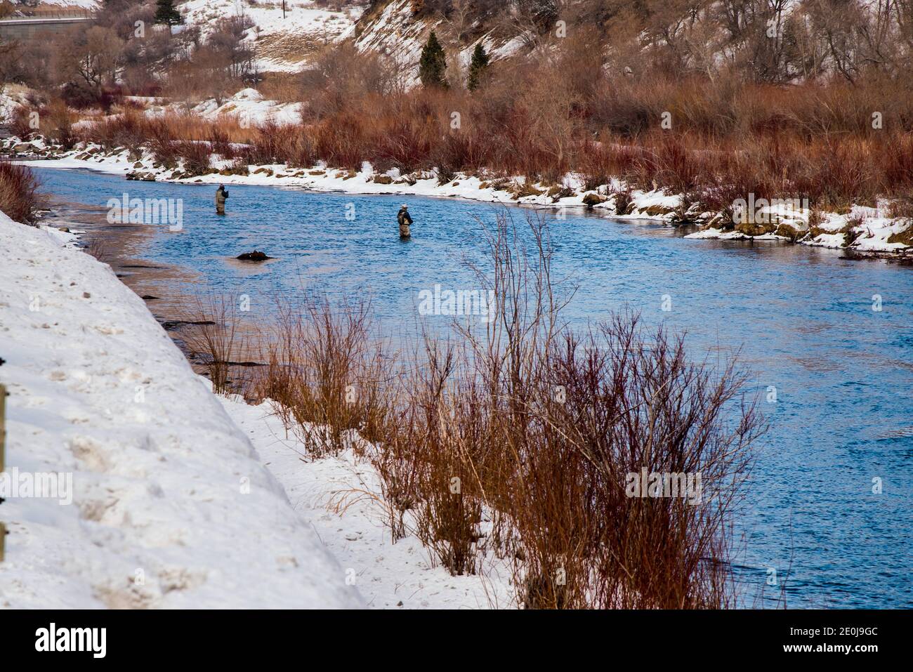 Fly fisherman, fishing in the cold waters of winter. Passion and interest for the sport is