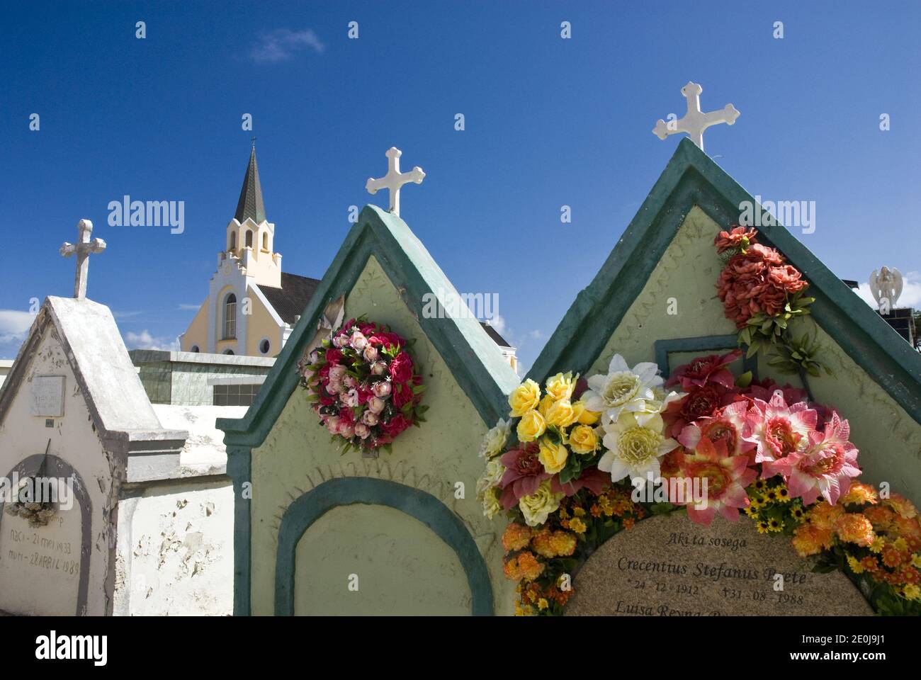 Colorful crypts in the cemetery next to the historic and colorful St. Anna's Catholic Church, Noord, Aruba. Stock Photo