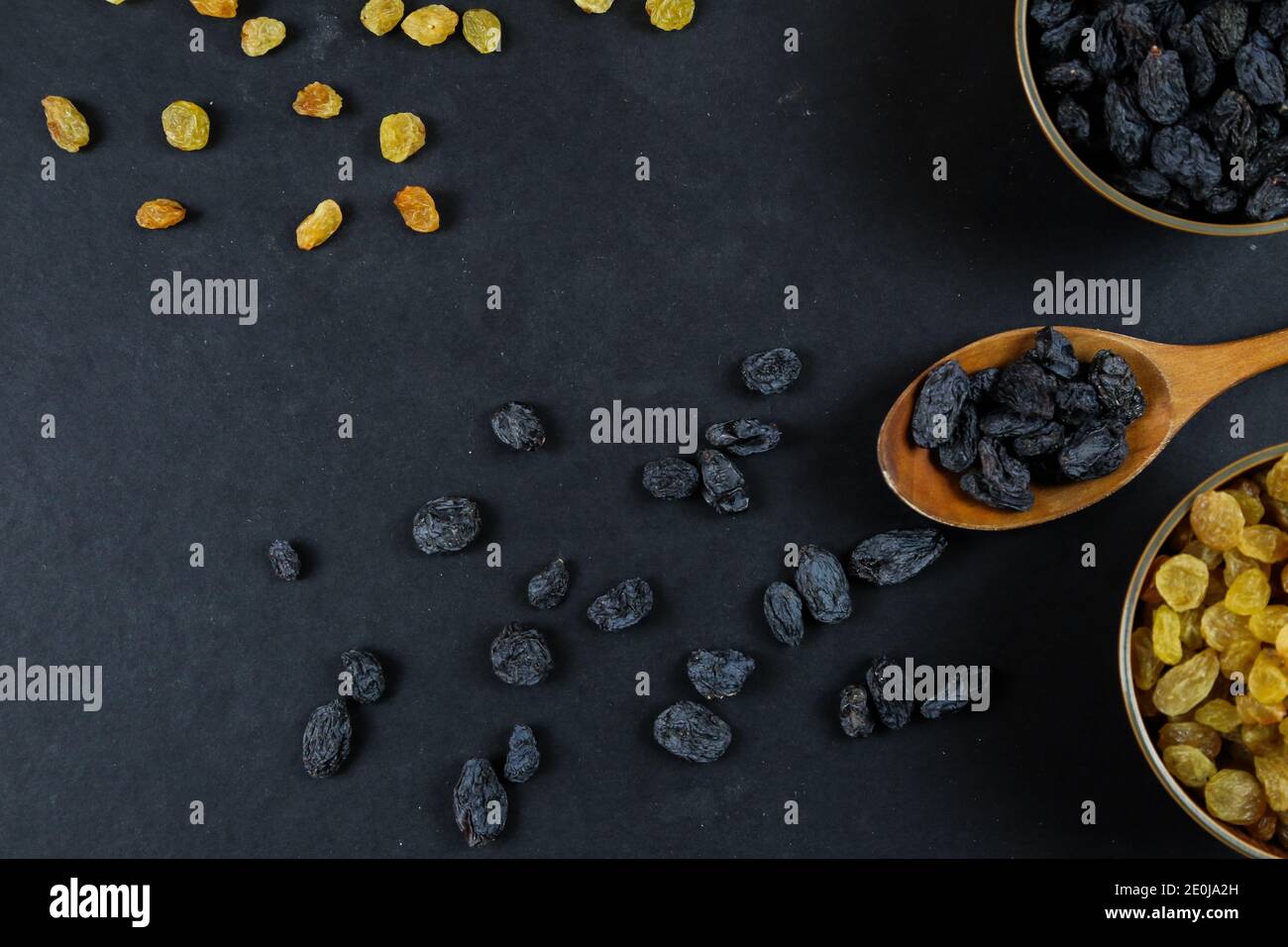 Dried raisins on black background Stock Photo