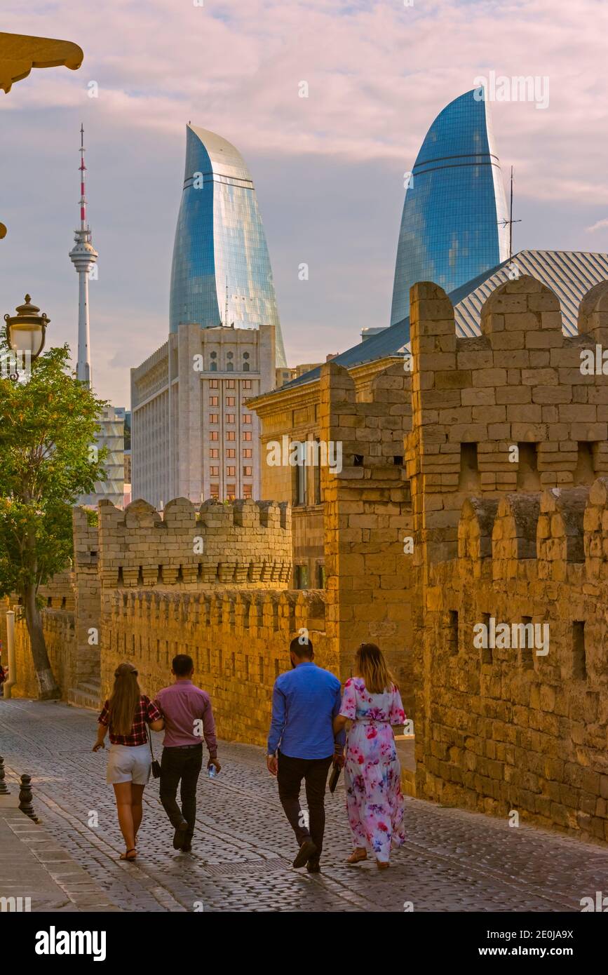 Old city walls and cobblestone street in the Old City, UNESCO World Heritage site, Flame Towers in the distance, Baku, Azerbaijan Stock Photo