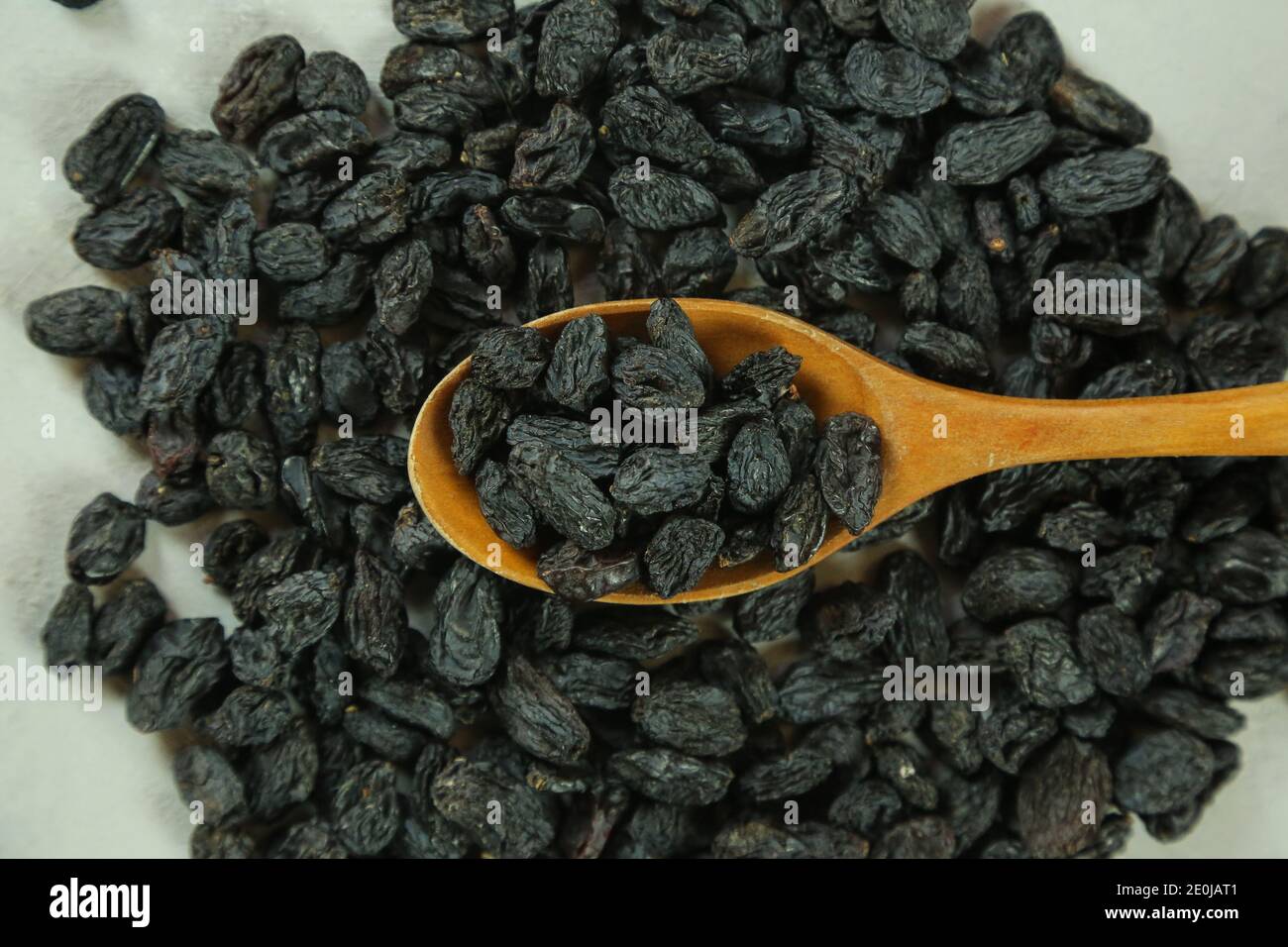 Dried raisins on white background Stock Photo - Alamy