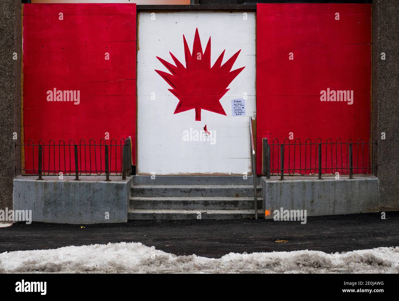 Plywood boards covering up windows in downtown London Ontario Canada