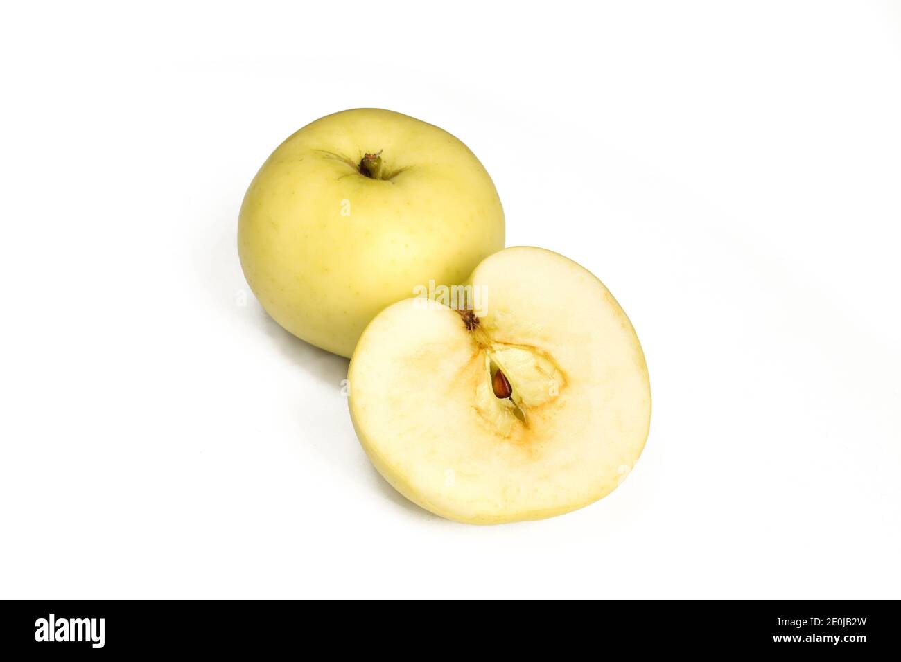 One and a half apple isolated on white background. Yellow fruit sliced Stock Photo