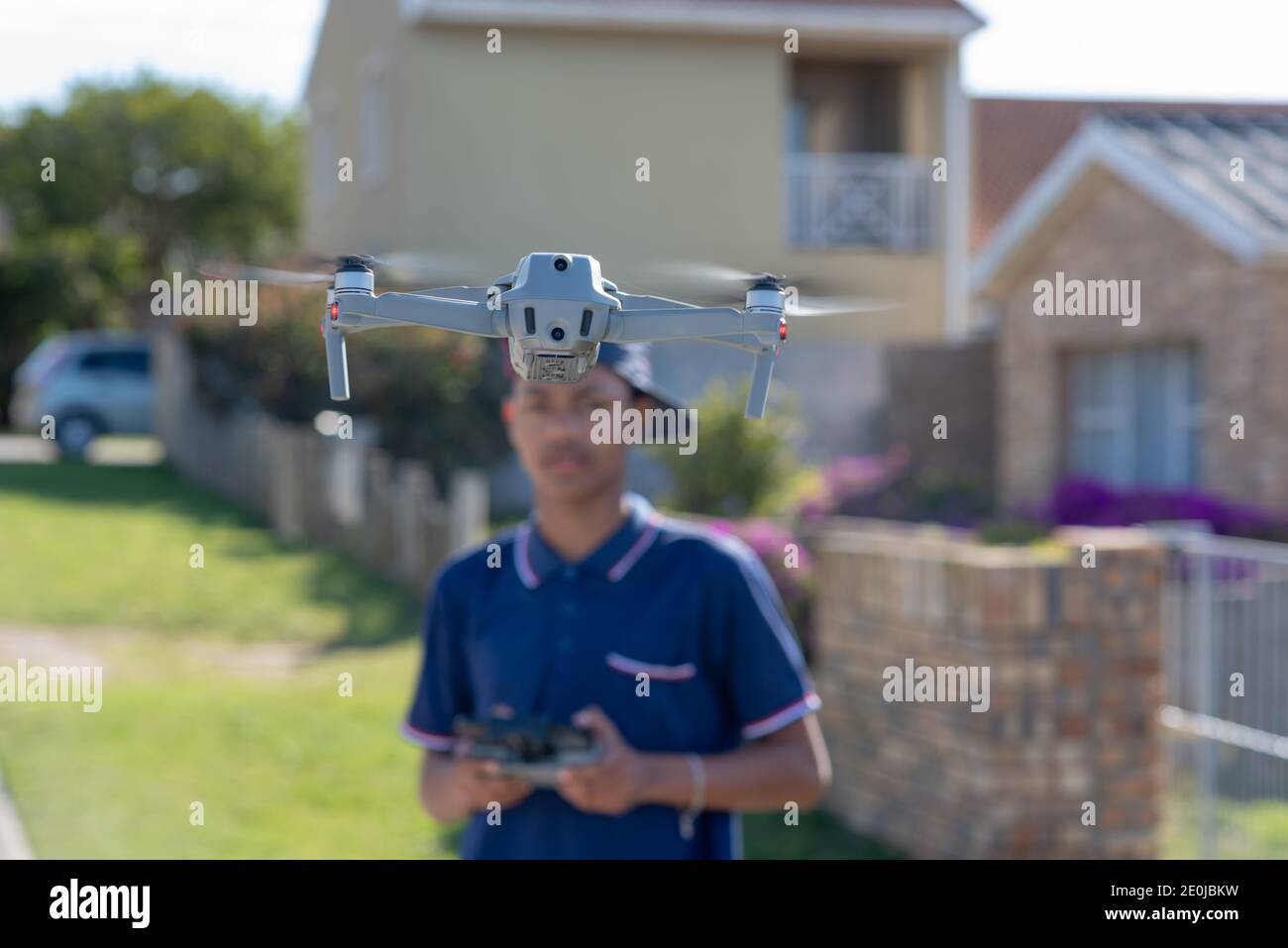 Port Elizabeth, South Africa October 2020 Close up shot of young boy flying DJI Mavic air 2 with blurred background Stock Photo