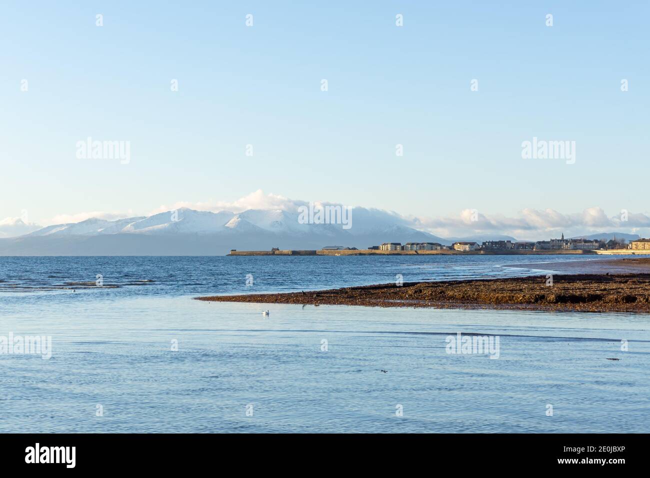 Stevenston Beach and the Isle of Arran on New Years day 2021. Saltcoats can also be seen in the far distance. Stock Photo