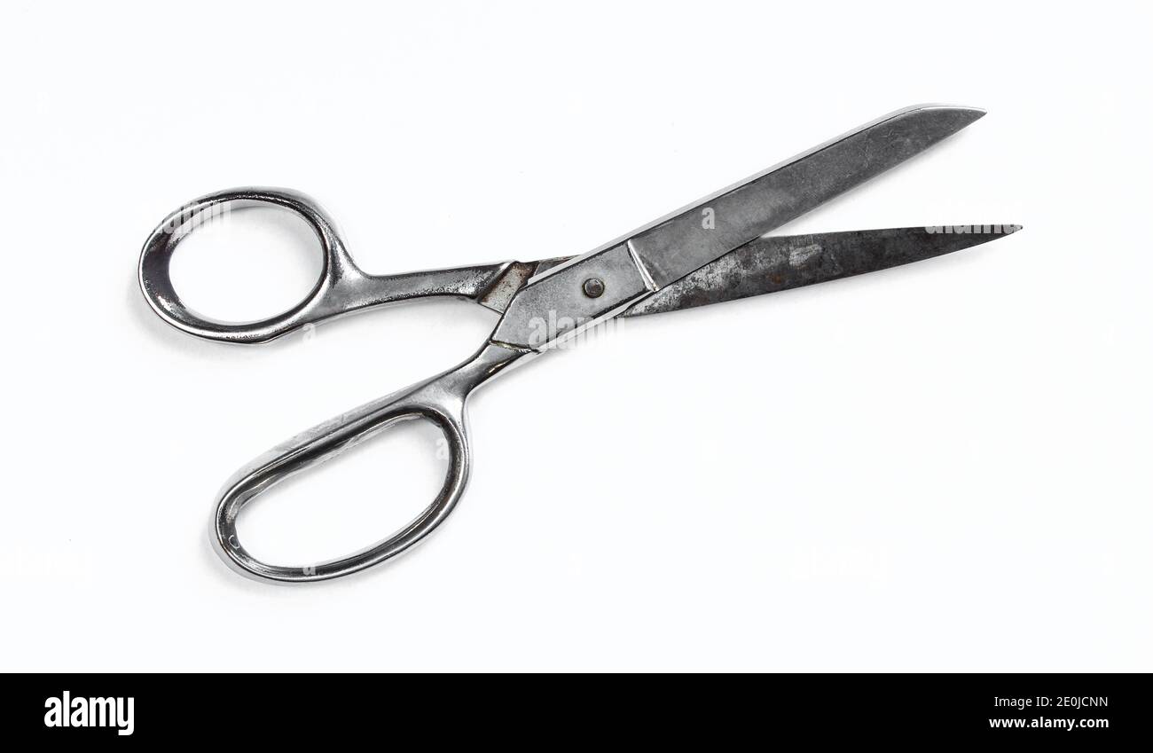 Old and rusty metallic scissors isolated on white background. Silver clippers Stock Photo