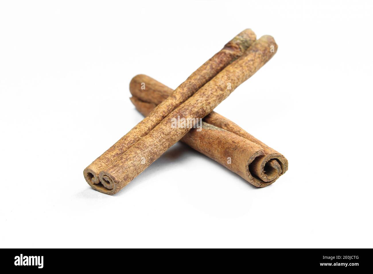 Brown cinnamon sticks isolated on white background. Aromatic food ingredients Stock Photo