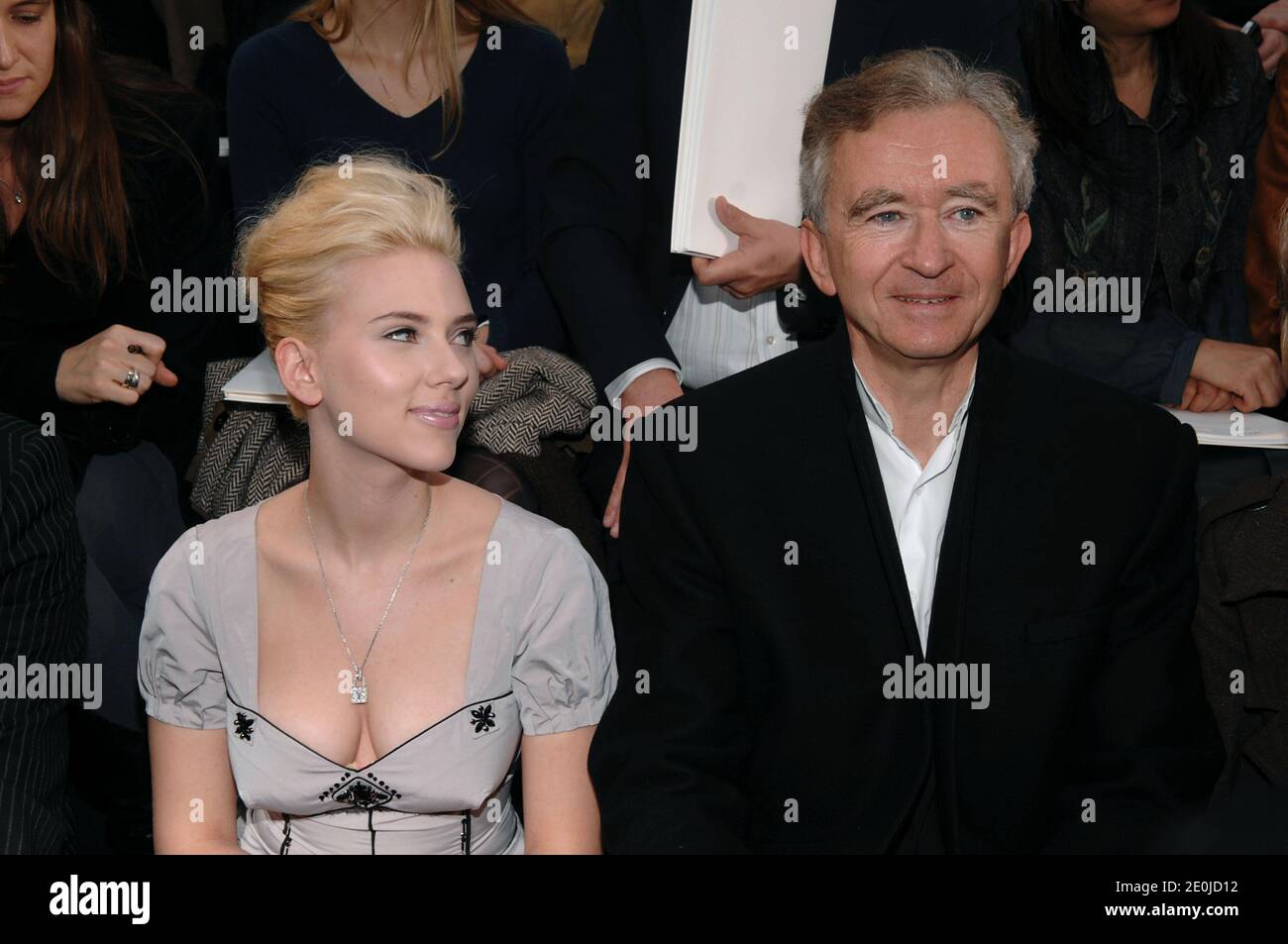 U.S. actress Sharon Stone poses surrounded by LVMH CEO Bernard Arnault (L)  and French Minister of Culture Renaud Donnedieu de Vabres upon arrival to  the cocktail reception for the inauguration of the