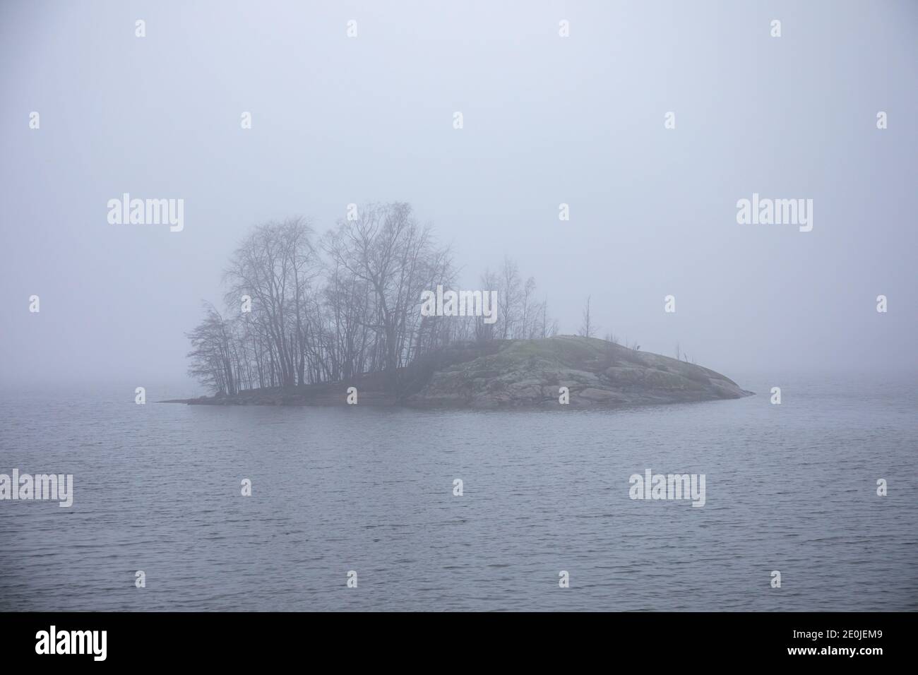 Little islet in Seurasaarensalmi on a foggy December day in Helsinki, Finland Stock Photo