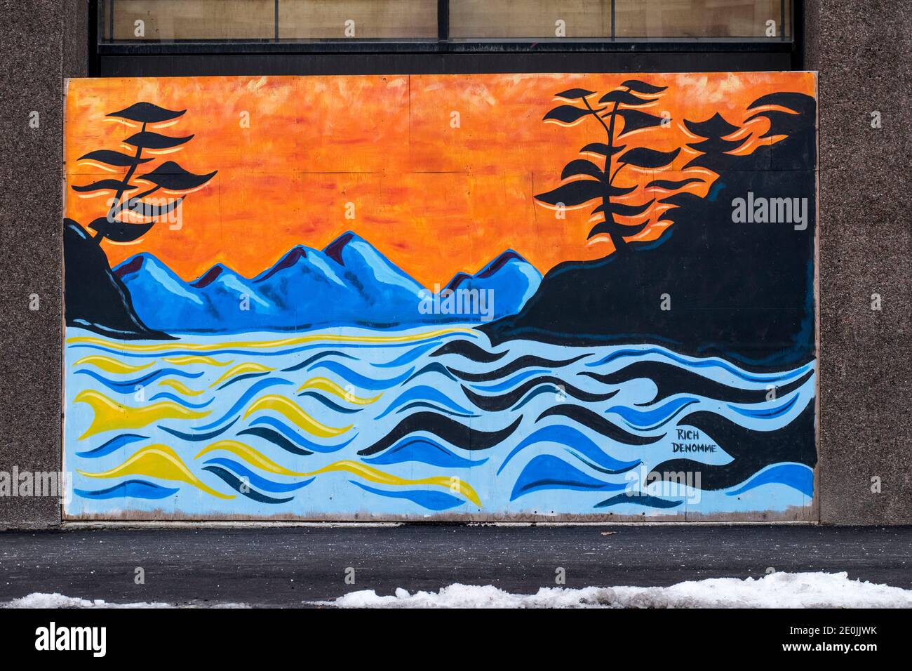 Plywood boards covering up windows in downtown London Ontario Canada