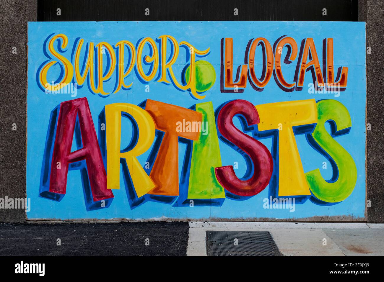 Plywood boards covering up windows in downtown London Ontario Canada