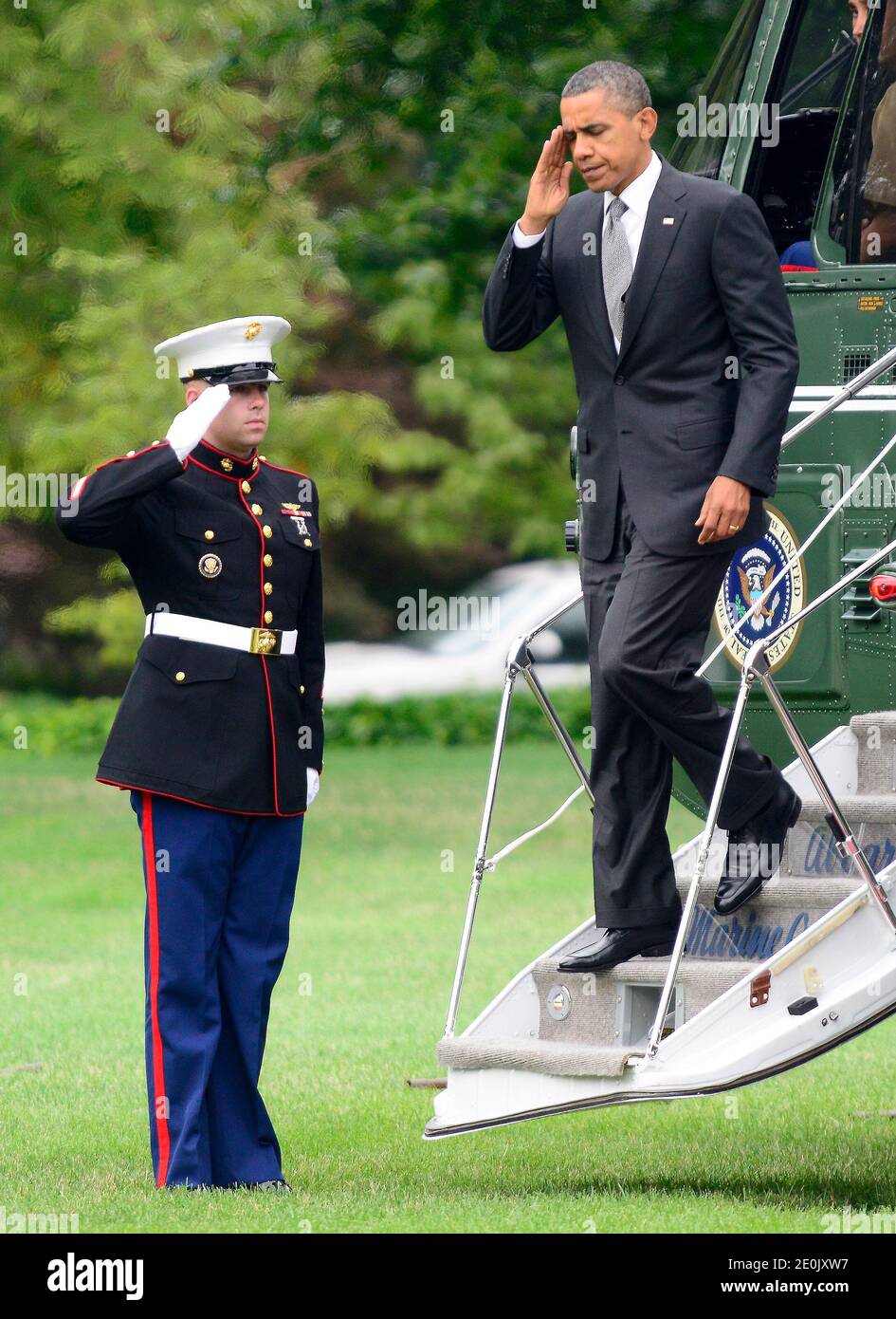 United States President Barack Obama salutes the Marine Guard as he arrives on the South Lawn of the White House in Washington, DC, USA, on July 20, 2012. The President was scheduled to spend most of the day campaigning in Florida but cut the trip short following the mass murder in Aurora, Colorado. Photo by Ron Sachs/ABACAPRESS.COM Stock Photo