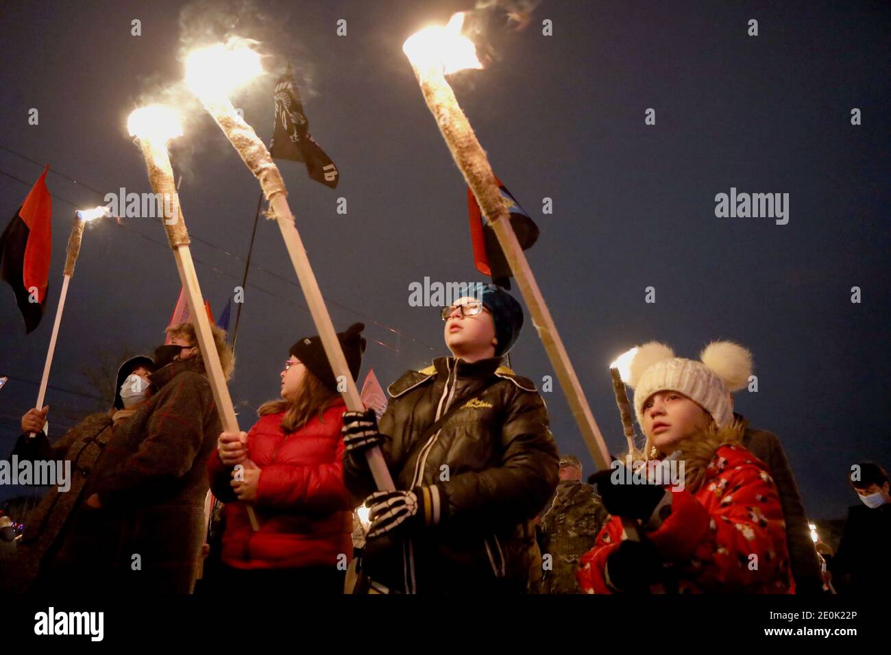 Non Exclusive: KYIV, UKRAINE - JANUARY 1, 2021 - Children hold the burning torches during the annual March of Honour, Dignity and Freedom on the 112th Stock Photo