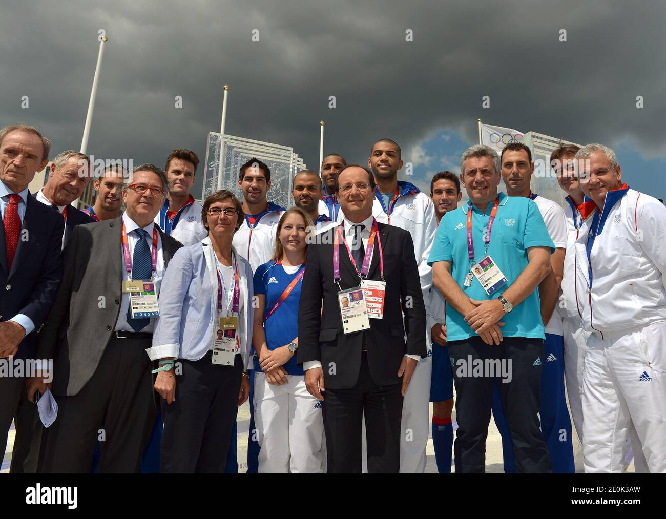 French President Francois Hollande (C) and French Sports Minister Valerie Fourneyron (3rdL) pose with French athletes Nikola Karabatic (6thL), silver medalist Celine Goberville (2ndL), baskettball players Tony Parker (C 2nd row)) and Nicolas Batum (6thR) and handball headcoach Claude Onesta (4thR) on July 30, 2012 at Olympic village in London, during the London 2012 Olympic Games. Photo by Gabriel Bouys/Pool/ABACAPRESS.COM Stock Photo