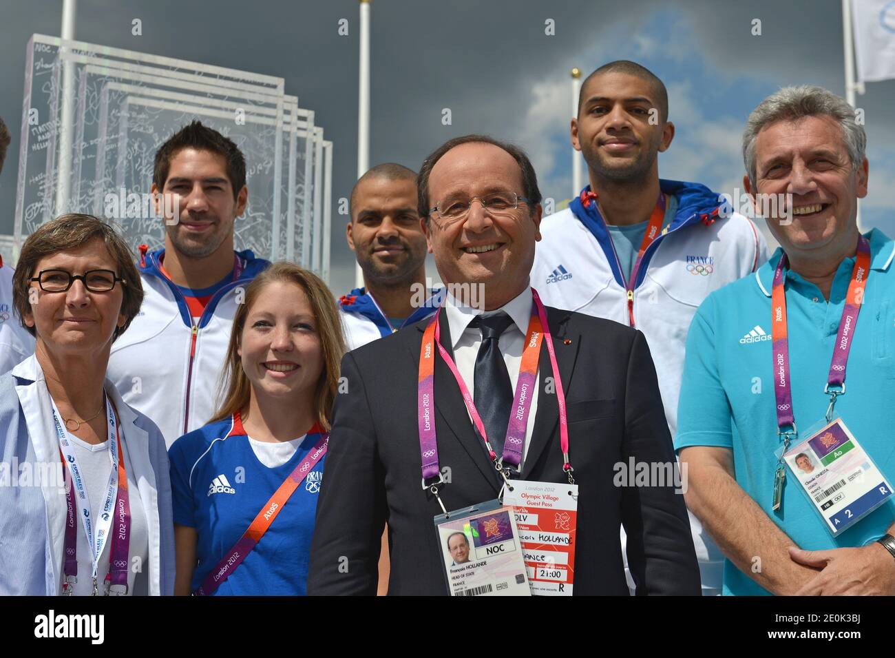 French President Francois Hollande (C) and French Sports Minister Valerie Fourneyron (L) pose with French athletes Nikola Karabatic (L, 2nd row), silver medalist Celine Goberville (2ndL), baskettball players Tony Parker (C) and Nicolas Batum (2ndR) and handball headcoach Claude Onesta (R) on July 30, 2012 at Olympic village in London, during the London 2012 Olympic Games. Photo by Gabriel Bouys/Pool/ABACAPRESS.COM Stock Photo