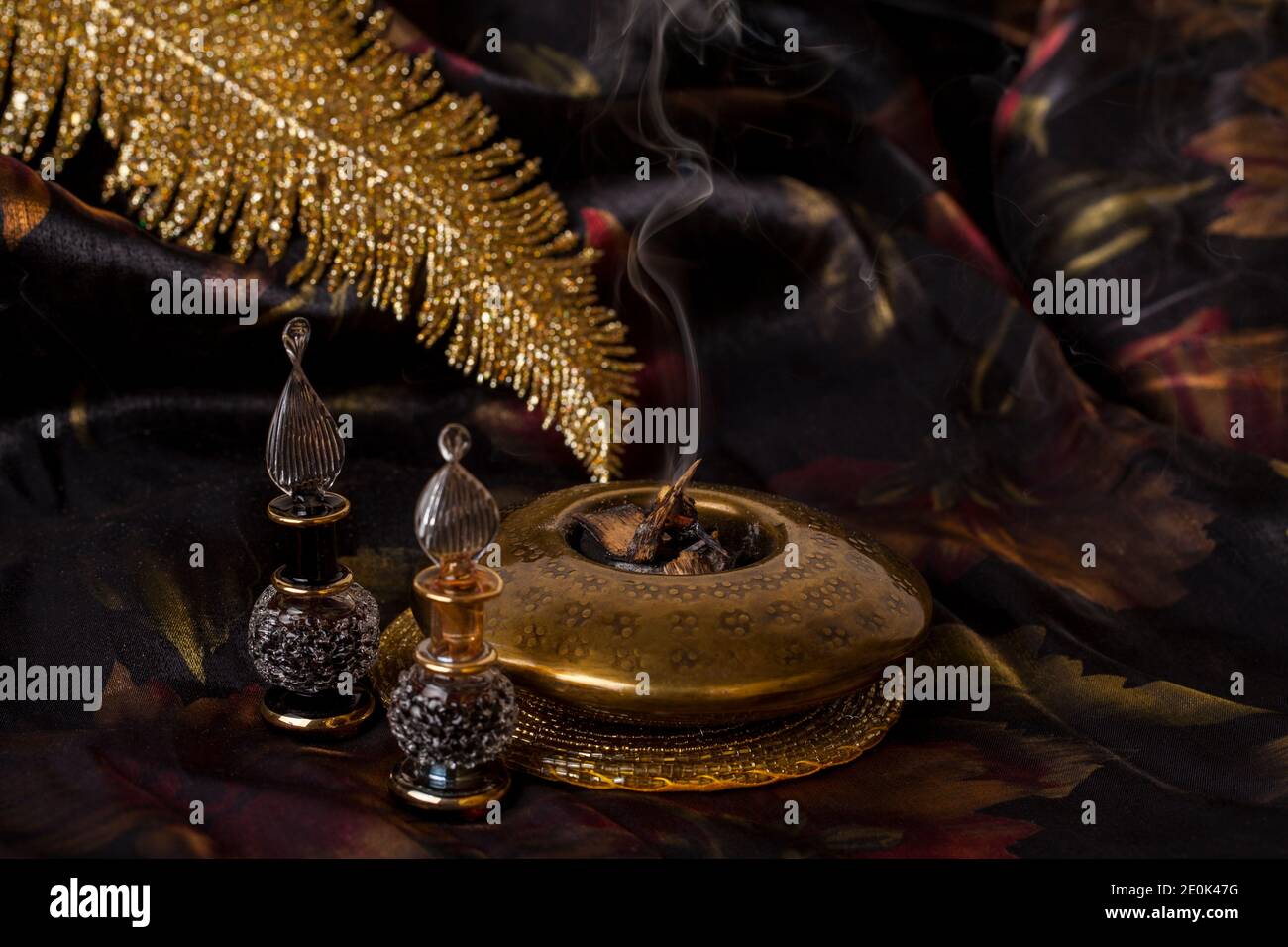 Agarwood, also called aloeswood, essential oil and burning incense chips Stock Photo