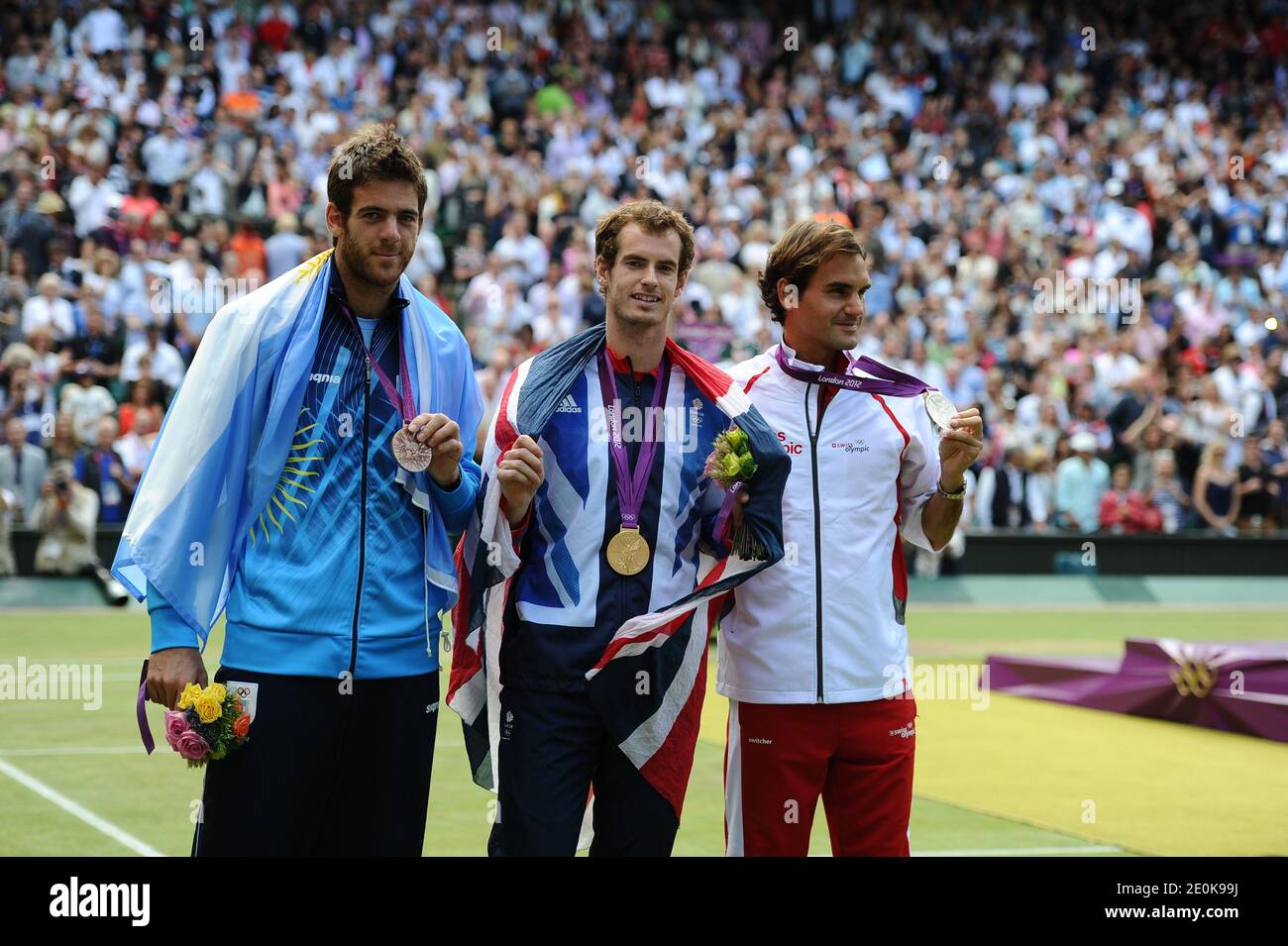Gold medalist Andy Murray (C) of Britain, silver medalist Roger Federer (L)  of Switzerland, and bronze medalist Juan Martin del Potro of Argentina pose  at awarding ceremony after the Final of the