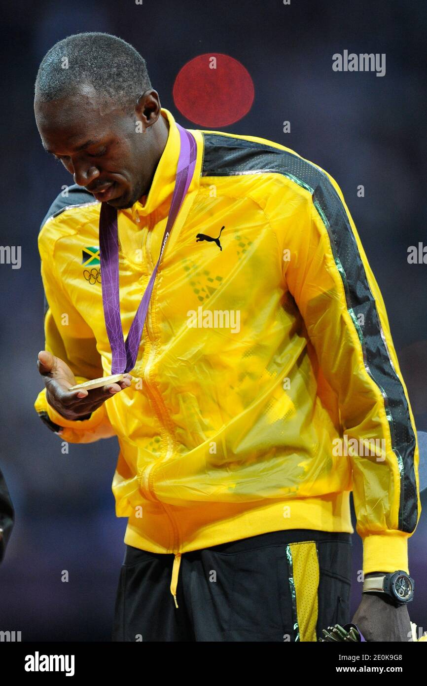 Gold medalist Usain Bolt of Jamaica displays his Olympic medals for the