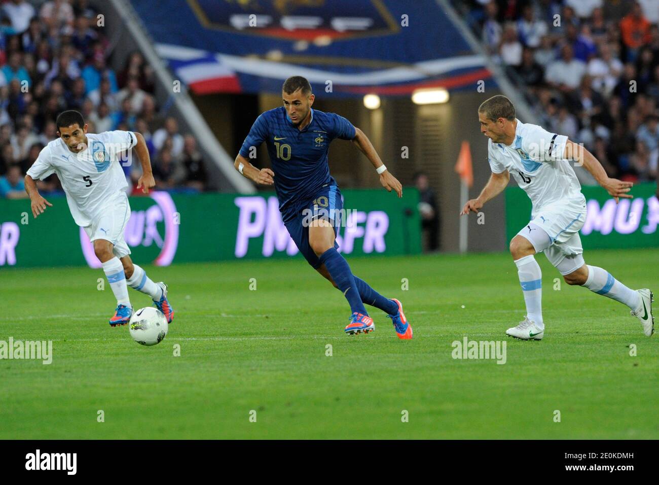 France's Karim Benzema battling Uruguay's Walter Gargano and Diego Perez during a friendly soccer match, France vs Uruguay in Le Havre, France, on August 15th, 2012. France and Uruguay drew 0-0. Photo by Henri Szwarc/ABACAPRESS.COM Stock Photo