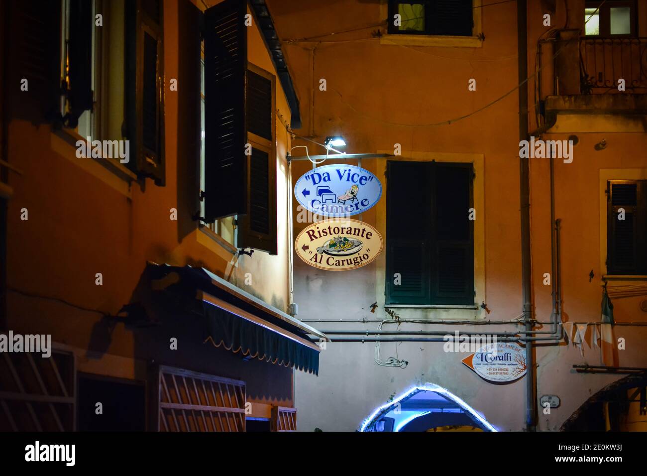 Night view of the Al Carugio Restaurant and Da Vice Inn sign in the village of Monterosso al Mare, Italy, part of the Cinque Terre. Stock Photo