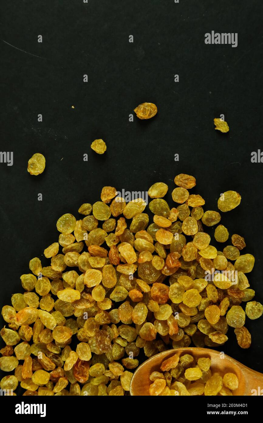 Dried raisins on black background Stock Photo