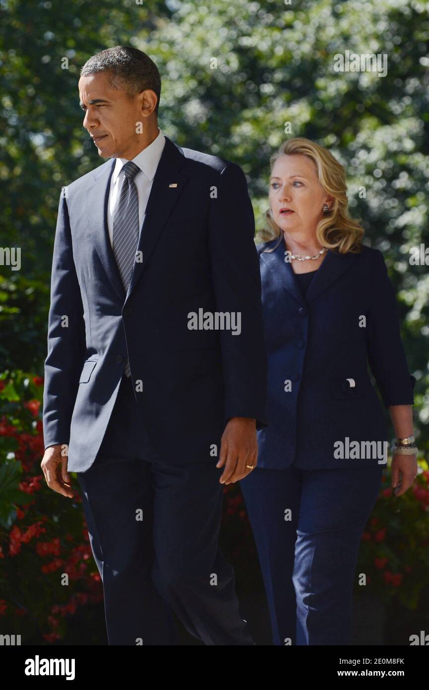 US President Barack Obama (L) walks down the Colonnade with US Secretary of State Hillary Clinton (R) to deliver remarks on the killing of US ambassador to Libya, Christopher Stevens, and three embassy staff, in the Rose Garden of the White House in Washington DC, USA on September 12, 2012. Gunmen attacked the US consulate in Benghazi, killing US ambassador to Libya, Christopher Stevens, late 11 September 2012, while another assault took place on the US embassy in Cairo. Photo by Michael Reynolds/Pool/ABACAPRESS.COM Stock Photo