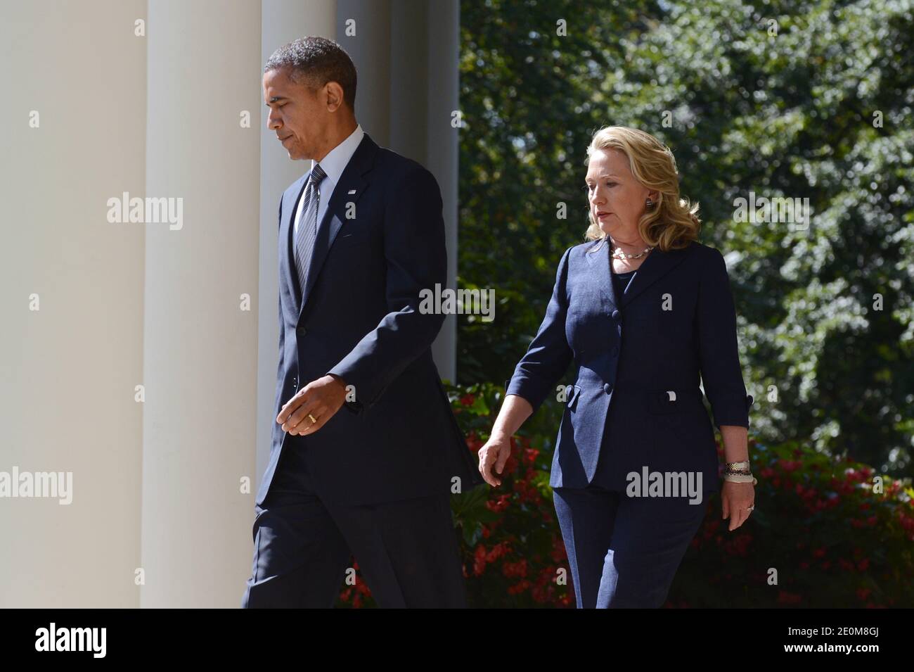 US President Barack Obama (L) walks down the Colonnade with US Secretary of State Hillary Clinton (R) to deliver remarks on the killing of US ambassador to Libya, Christopher Stevens, and three embassy staff, in the Rose Garden of the White House in Washington DC, USA on September 12, 2012. Gunmen attacked the US consulate in Benghazi, killing US ambassador to Libya, Christopher Stevens, late 11 September 2012, while another assault took place on the US embassy in Cairo. Photo by Michael Reynolds/Pool/ABACAPRESS.COM Stock Photo