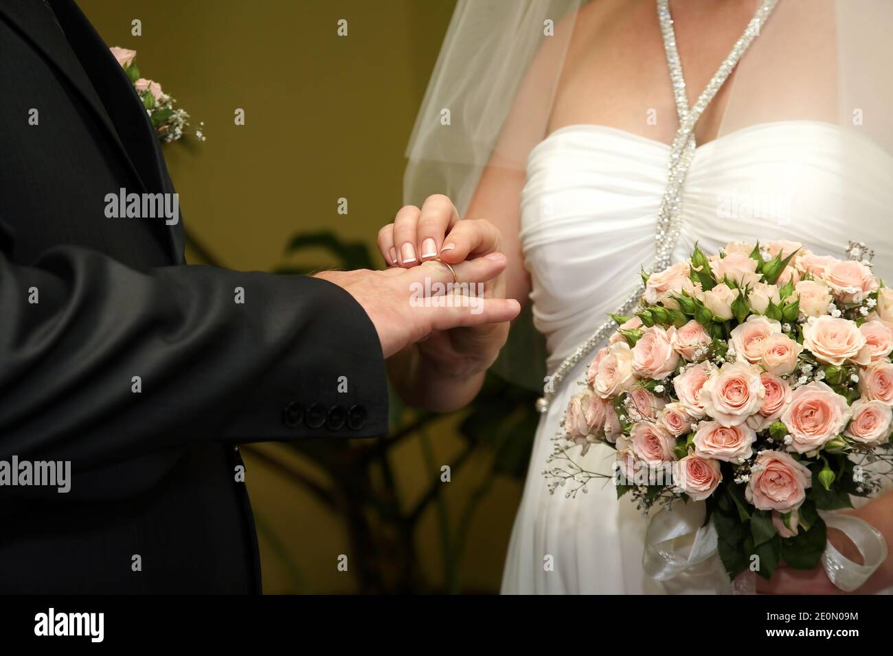 bride and groom wear wedding rings to each other Stock Photo Alamy
