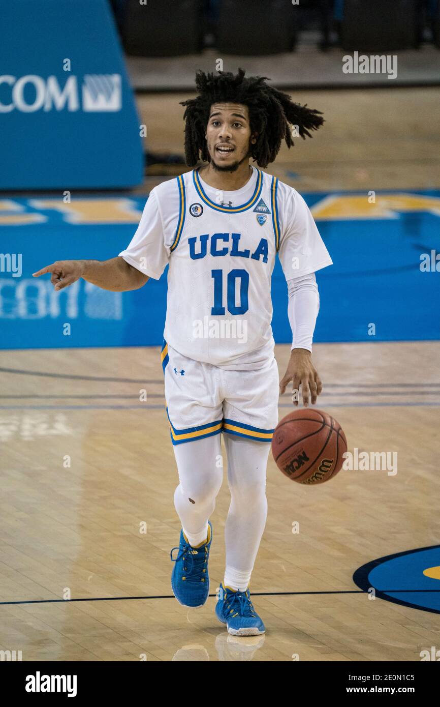 UCLA Bruins guard Tyger Campbell (10) brings the ball up court against the Utah Utes during an NCAA college basketball game, Thursday, Dec. 31, 2020, Stock Photo