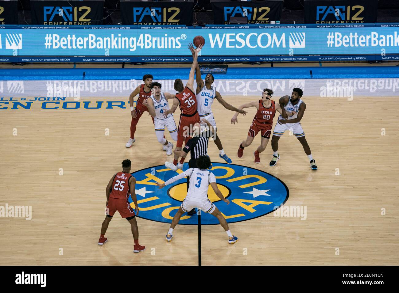 Utah Utes center Branden Carlson (35) and UCLA Bruins guard Chris Smith (5) jump for the opening tip during an NCAA college basketball game, Thursday, Stock Photo